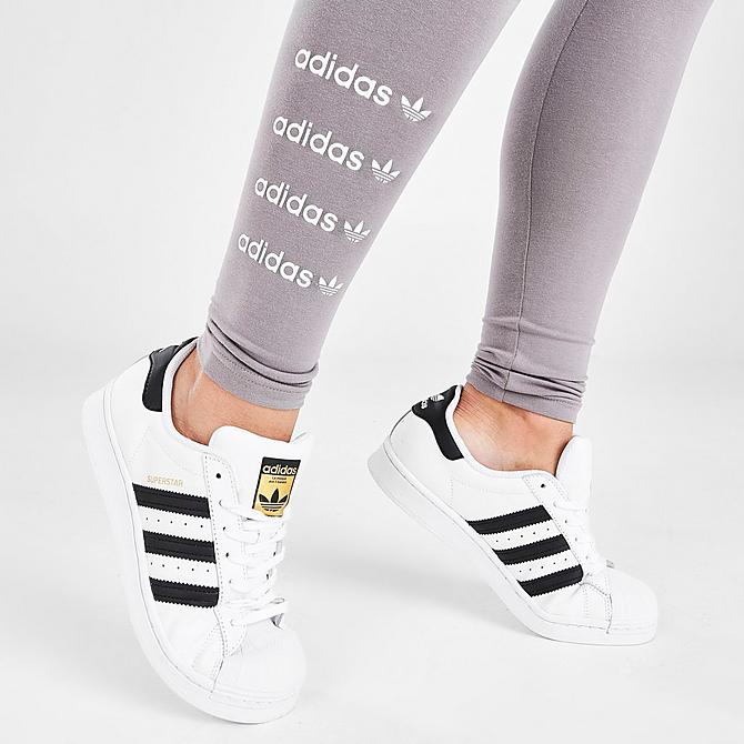 white and black adidas superstar worn with leggings